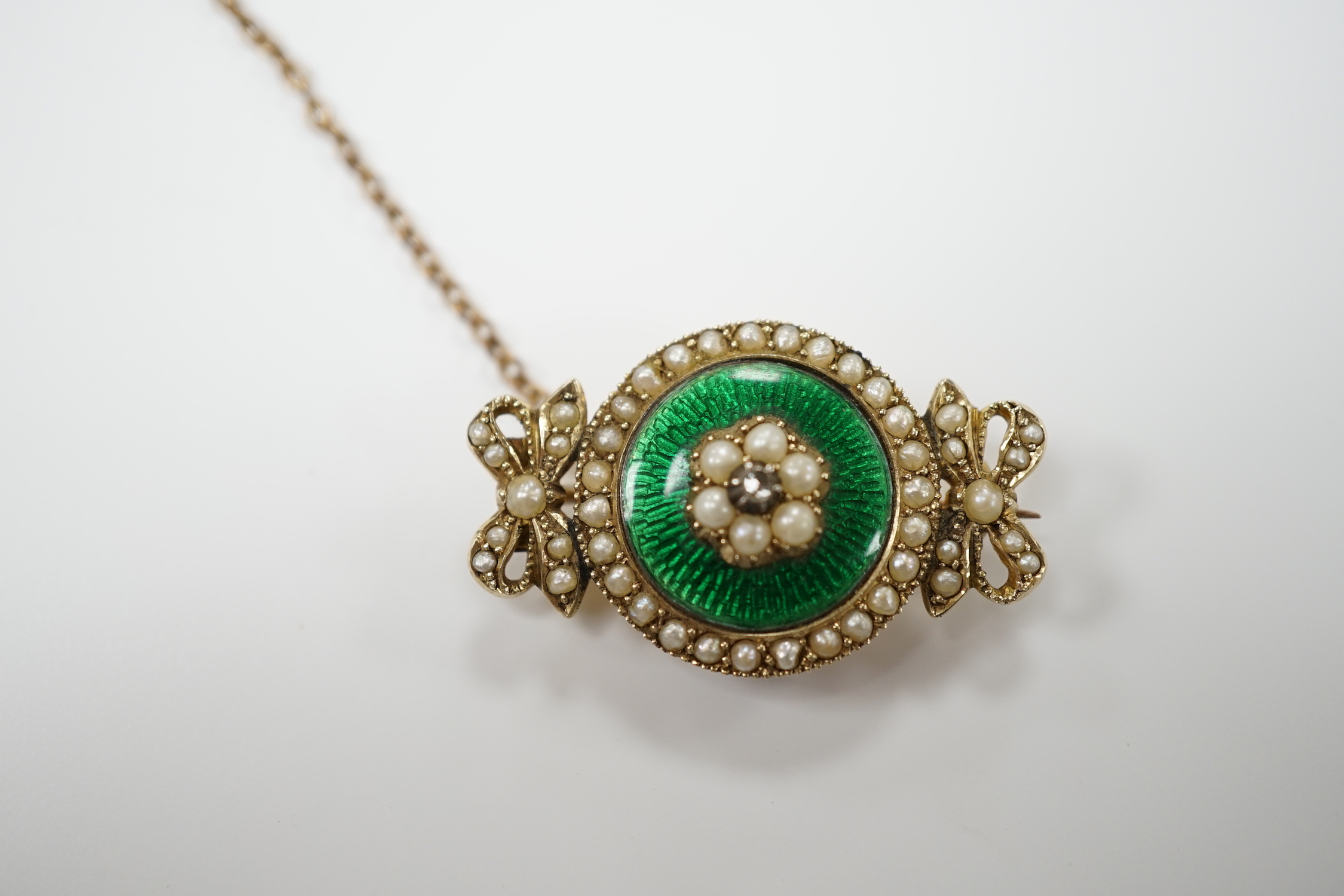 An early 20th century yellow metal, enamel, diamond and seed pearl set brooch, 30mm, gross weight 6.9 grams.